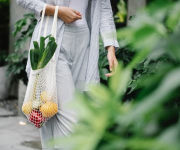 a woman in whose hands a ribbon of organic material with bio food